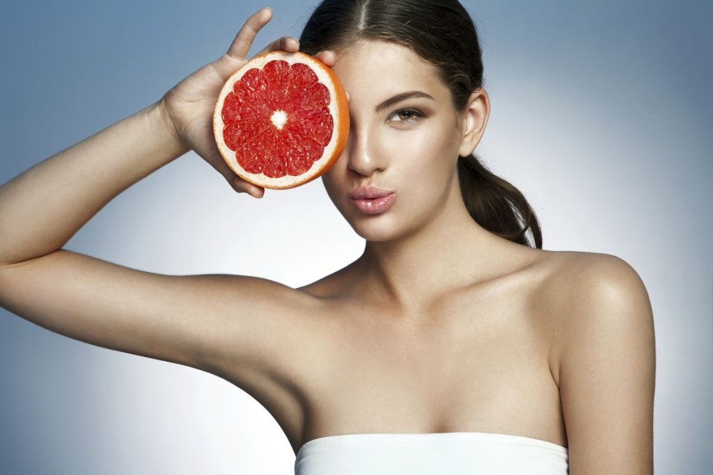 Lovely girl with pomelo slice, natural organic raw fresh food