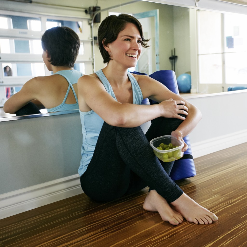04 Apr 2014 --- Caucasian woman smiling in yoga studio --- Image by © Peathegee Inc/Blend Images/Corbis